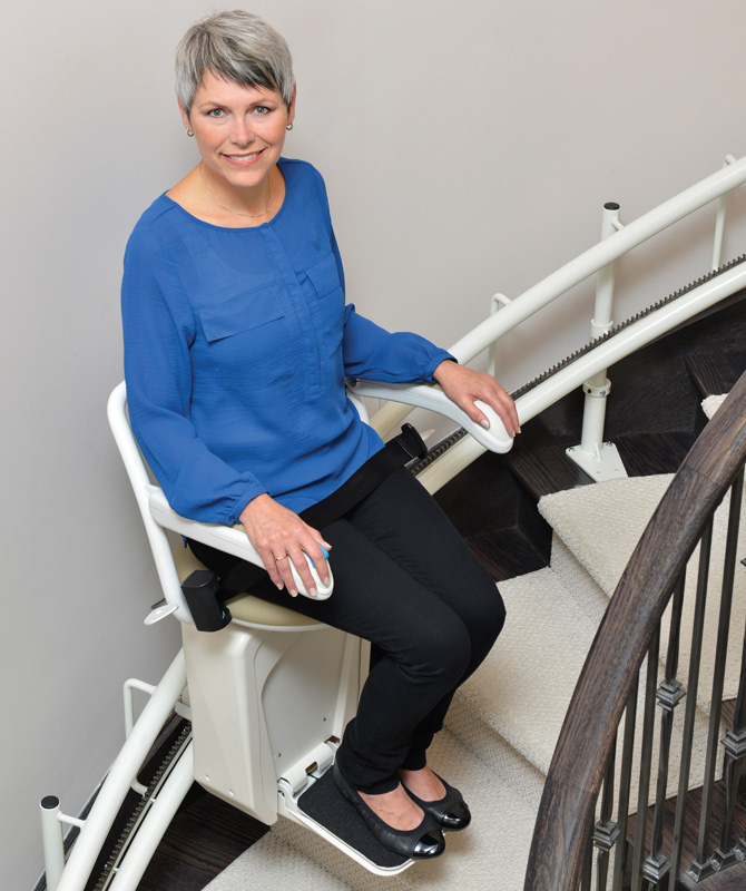 Savaria stairlift with person riding it